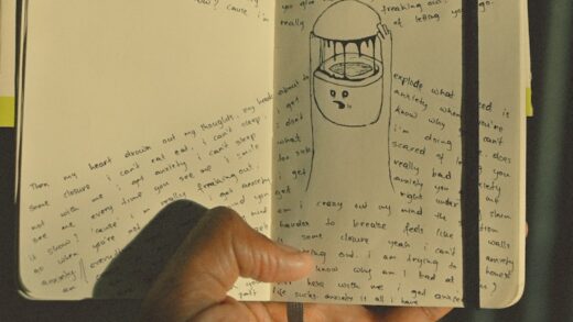person holding white printer paper with drawing